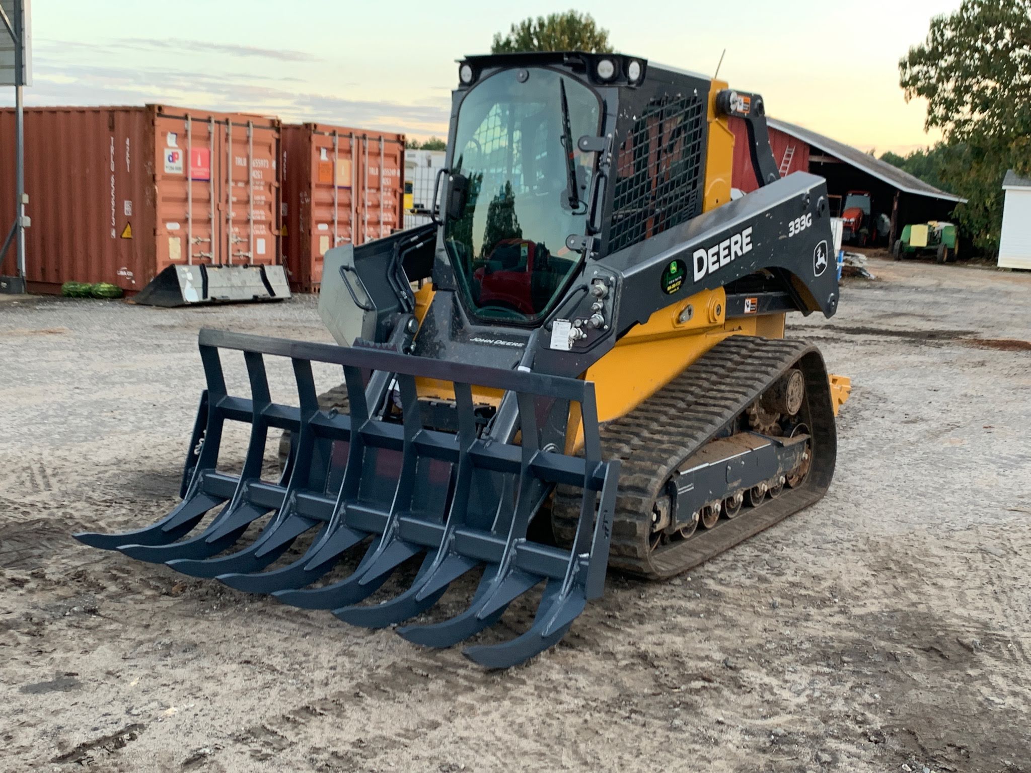 The Rake Shop root rake mounted on a compact track loader